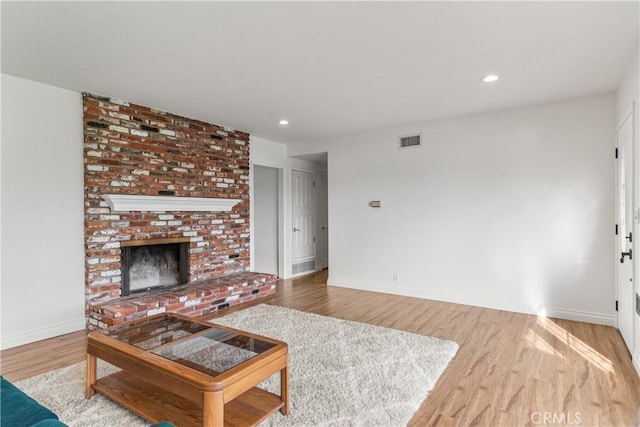 living room featuring a fireplace and light hardwood / wood-style flooring