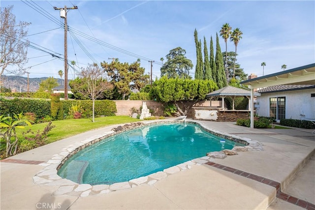 view of swimming pool featuring a lawn, a patio, and an outdoor bar