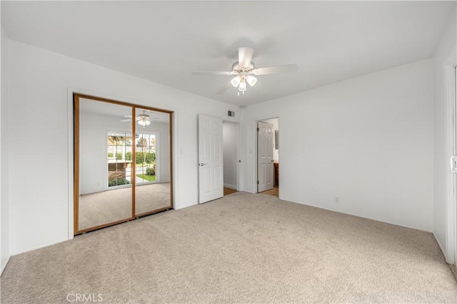 unfurnished bedroom featuring carpet flooring and ceiling fan