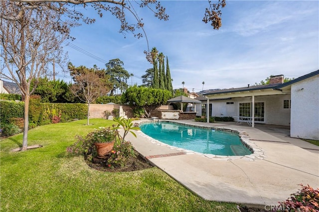 view of pool featuring a lawn and a patio