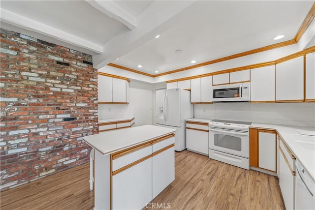 kitchen with white appliances, crown molding, light hardwood / wood-style flooring, white cabinetry, and brick wall