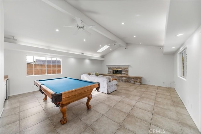 rec room with ceiling fan, vaulted ceiling with beams, billiards, a fireplace, and light tile patterned floors