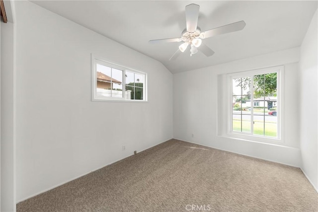 carpeted empty room with plenty of natural light and ceiling fan