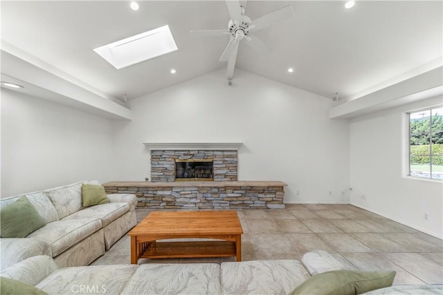 living room featuring a fireplace, vaulted ceiling, ceiling fan, and light tile patterned flooring