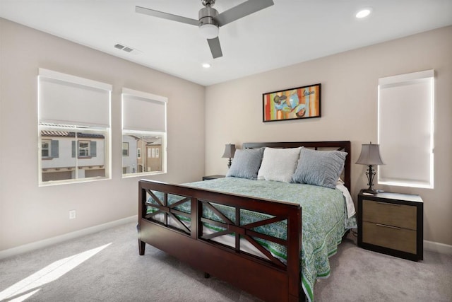 bedroom featuring light colored carpet and ceiling fan