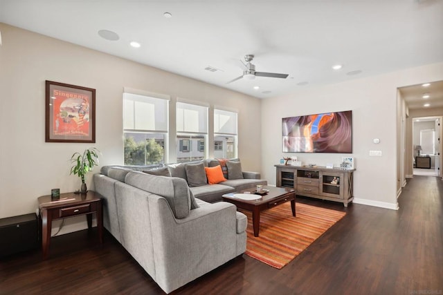 living room with ceiling fan and dark wood-type flooring