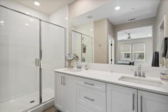 bathroom with vanity, a shower with door, and ceiling fan