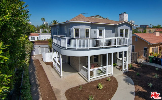 rear view of property featuring a patio area