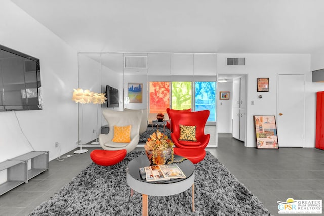 living room with dark tile patterned flooring