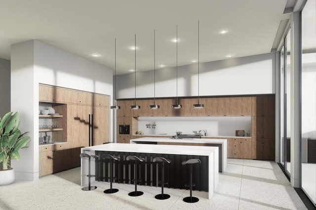 kitchen with a high ceiling, a breakfast bar, pendant lighting, and a large island