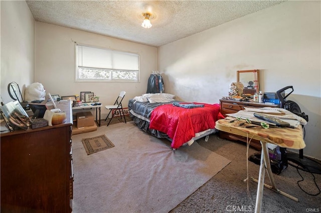 bedroom featuring a textured ceiling and carpet floors