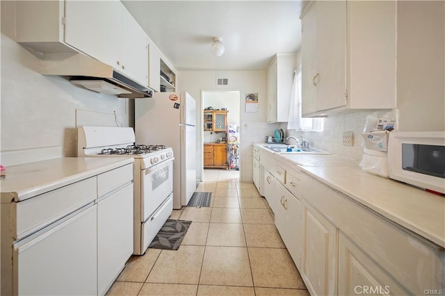 kitchen with sink, white cabinets, backsplash, white appliances, and light tile patterned floors