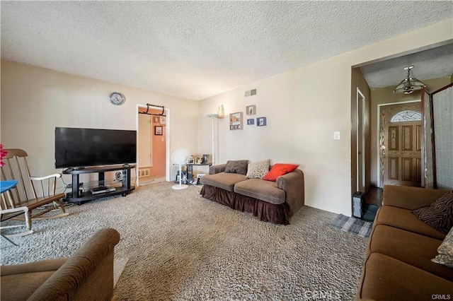 living room featuring carpet flooring, vaulted ceiling, and a textured ceiling