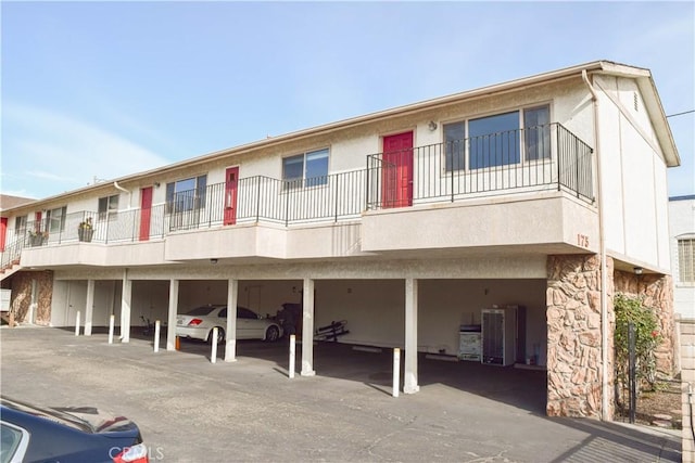 view of front of property with a carport and cooling unit