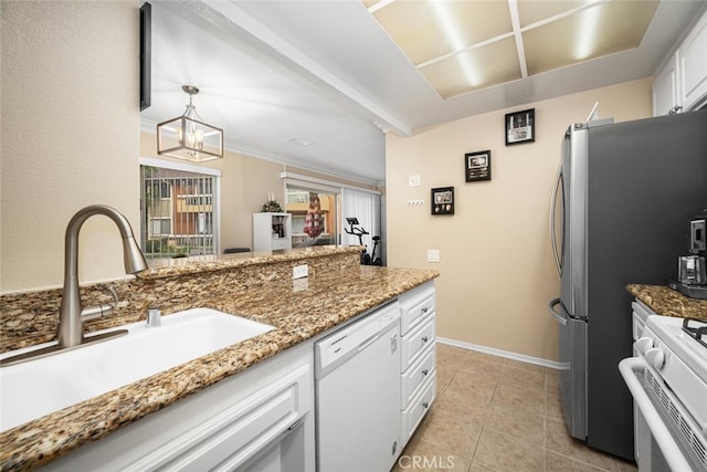 kitchen featuring sink, white dishwasher, decorative light fixtures, white cabinets, and range