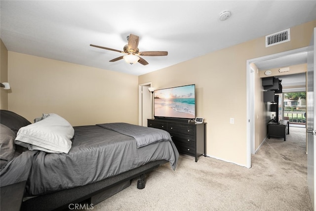 bedroom with light colored carpet and ceiling fan