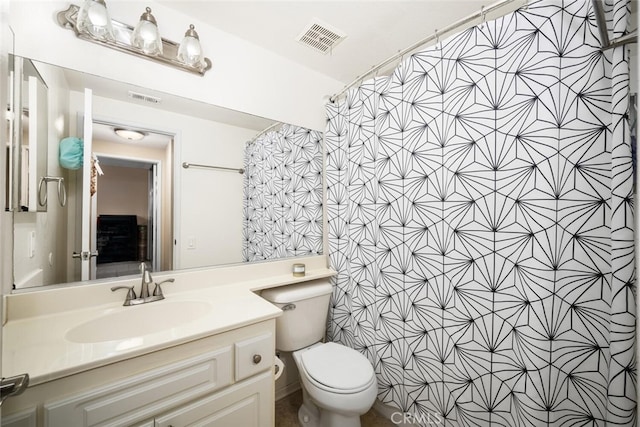 bathroom with curtained shower, vanity, and toilet