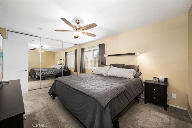 carpeted bedroom featuring ceiling fan and a closet