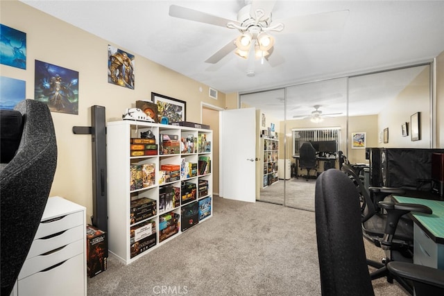 office space with light colored carpet and ceiling fan