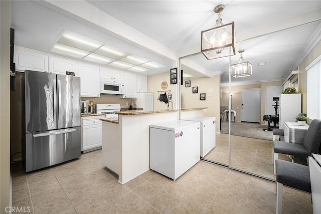 kitchen featuring light stone countertops, ornamental molding, white appliances, white cabinetry, and hanging light fixtures