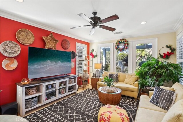 living room featuring crown molding and ceiling fan