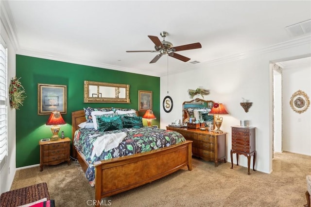 carpeted bedroom with ceiling fan and ornamental molding