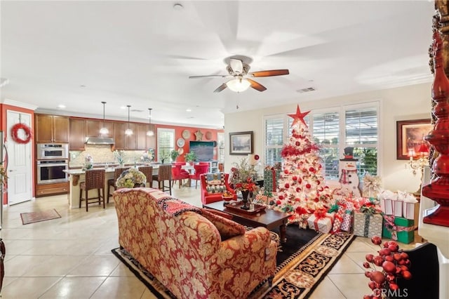 living room featuring light tile patterned floors, ceiling fan, and ornamental molding