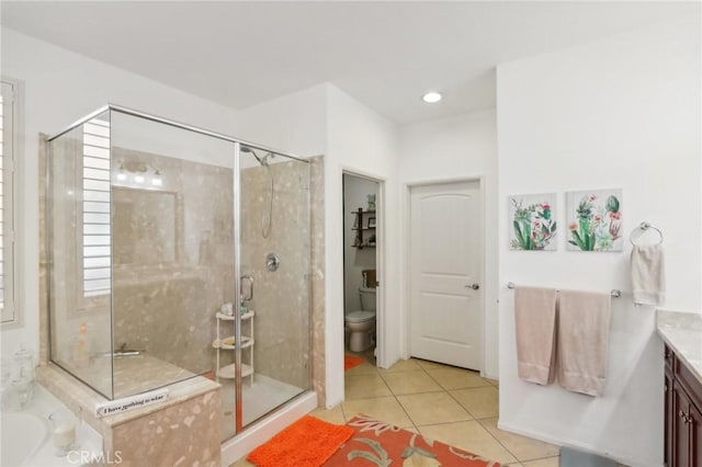 full bathroom featuring tile patterned floors, separate shower and tub, vanity, and toilet