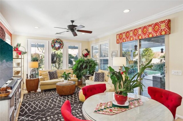 sunroom / solarium featuring ceiling fan