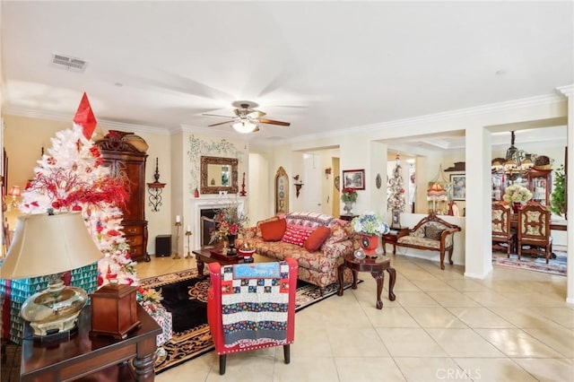 tiled living room featuring ceiling fan with notable chandelier and ornamental molding