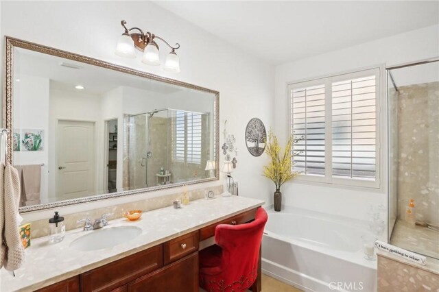 bathroom with plus walk in shower and vanity