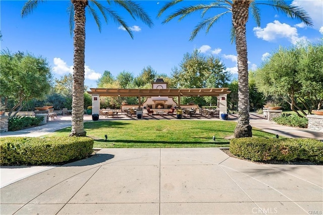 view of home's community featuring a lawn and a pergola