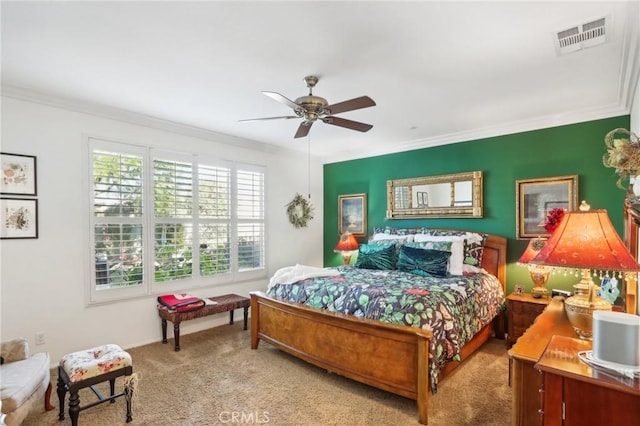 carpeted bedroom featuring ceiling fan and ornamental molding