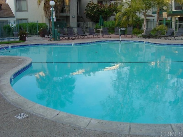 community pool featuring fence