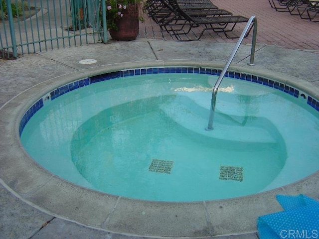 view of swimming pool featuring a community hot tub