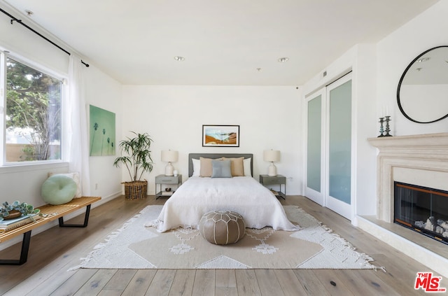 bedroom featuring access to outside and light hardwood / wood-style floors