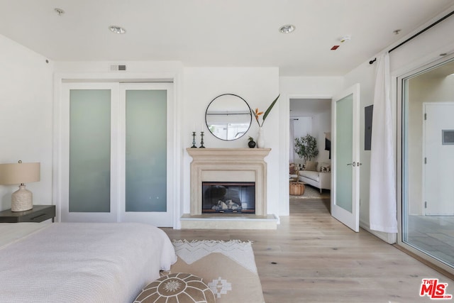 bedroom with a closet and light hardwood / wood-style floors