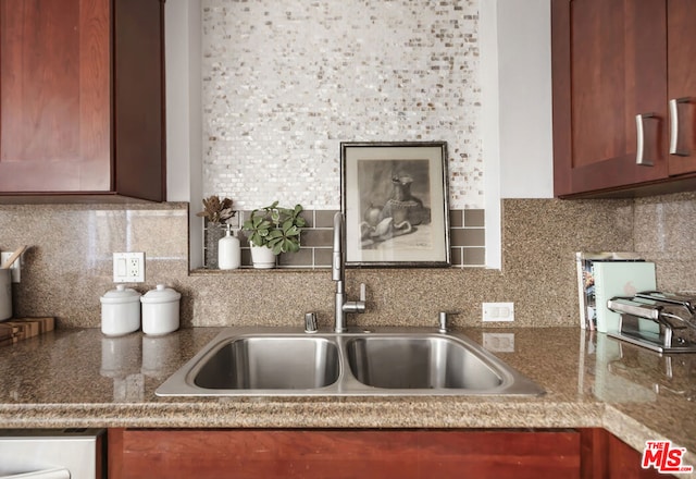 kitchen featuring tasteful backsplash and sink