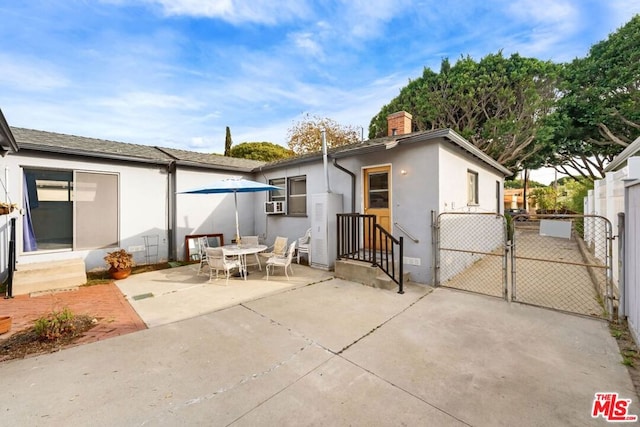 back of property with a patio area and cooling unit