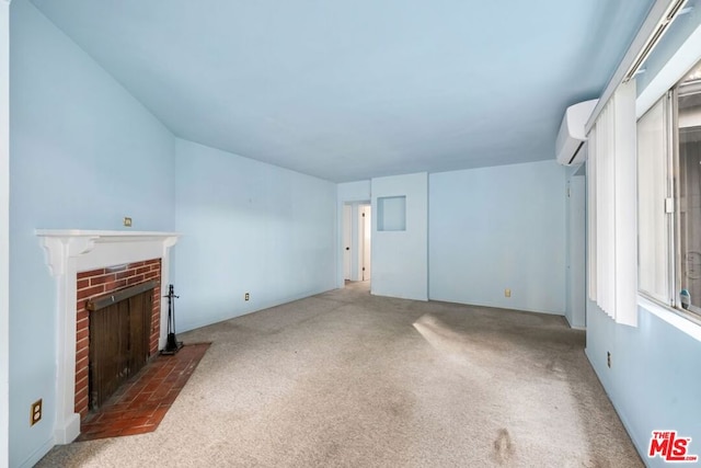 unfurnished living room featuring dark carpet, a brick fireplace, and a wall mounted AC