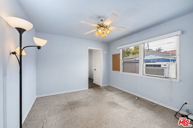 carpeted spare room featuring ceiling fan and cooling unit