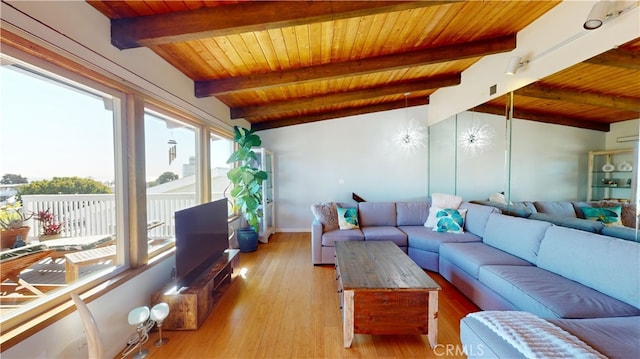 living room with lofted ceiling with beams, light hardwood / wood-style flooring, and wood ceiling