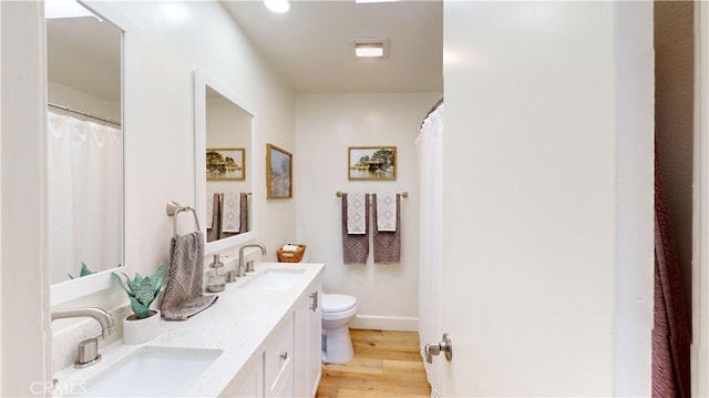 bathroom featuring hardwood / wood-style floors, vanity, and toilet