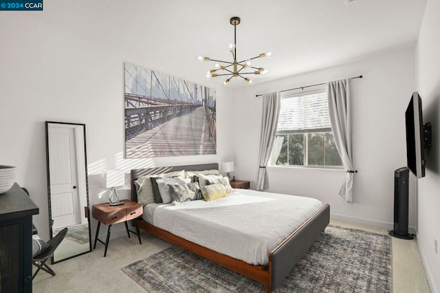 carpeted bedroom featuring an inviting chandelier