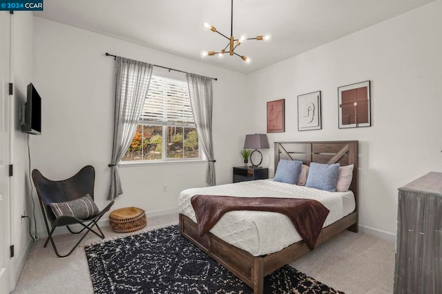 bedroom with a chandelier and light colored carpet