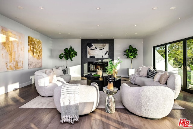 living room with hardwood / wood-style flooring and a high end fireplace