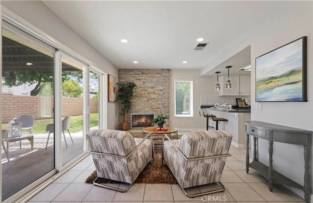 tiled living room featuring a fireplace