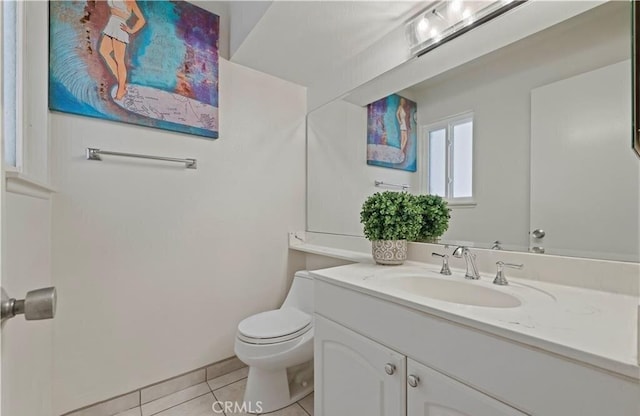 bathroom featuring tile patterned floors, vanity, and toilet