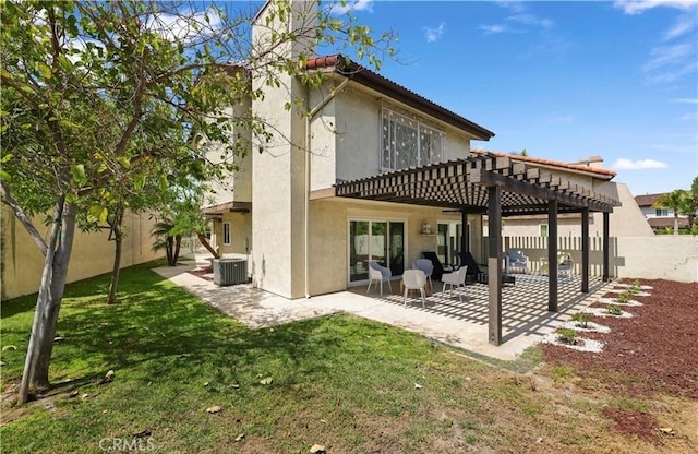 rear view of house with a pergola, a patio, central AC unit, and a lawn