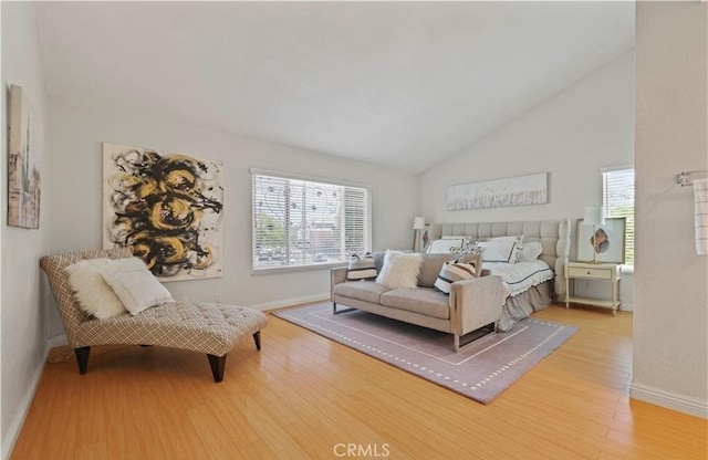 bedroom featuring high vaulted ceiling and wood-type flooring